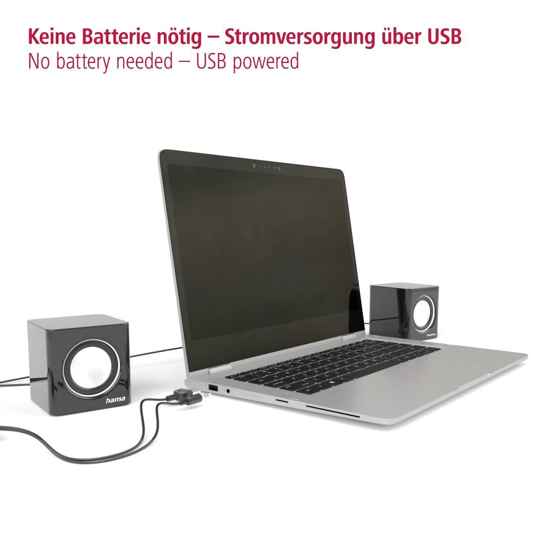 Prenosnik povezan z dvema zvočnikoma prek USB, z besedilom »Ni potrebna baterija – napajanje prek USB«, kar pomeni, da se napaja iz USB.
