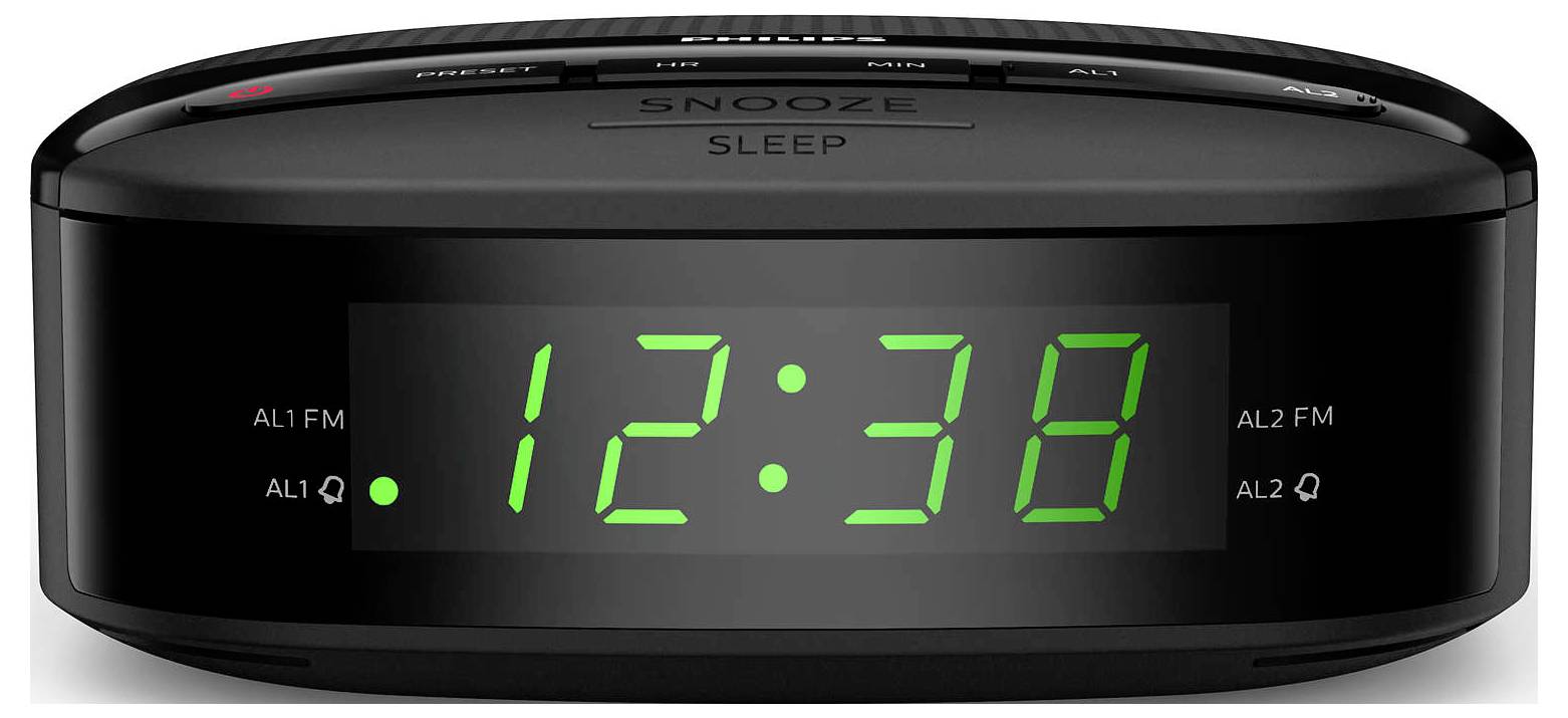 Črna digitalna budilka s številkami 12:38 prikazanimi v zelenih LED-ih, s tipkami za odložitev in spanje na vrhu in indikatorji alarma na zaslonu