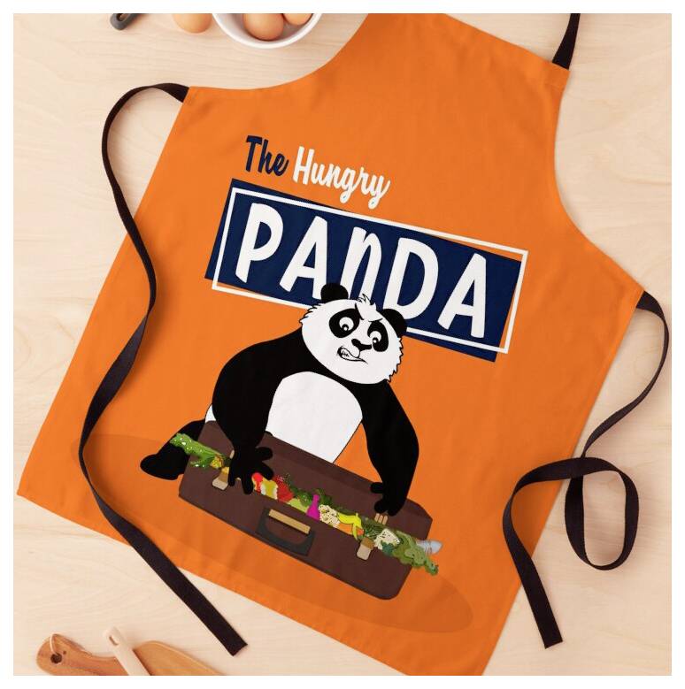 Oranžna predpasnik z napisom "The Hungry PANDA" in risano pandaljo, ki drži kovček, prikazana razgrnjena s črnimi vezalkami.