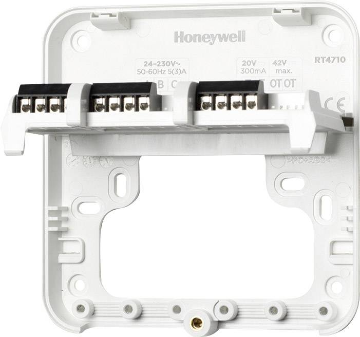 'Zadnja stran osnovne plošče Honeywell termostata, model RT4710, z več priključnimi sponkami za električno napeljavo, ki so vidne.'