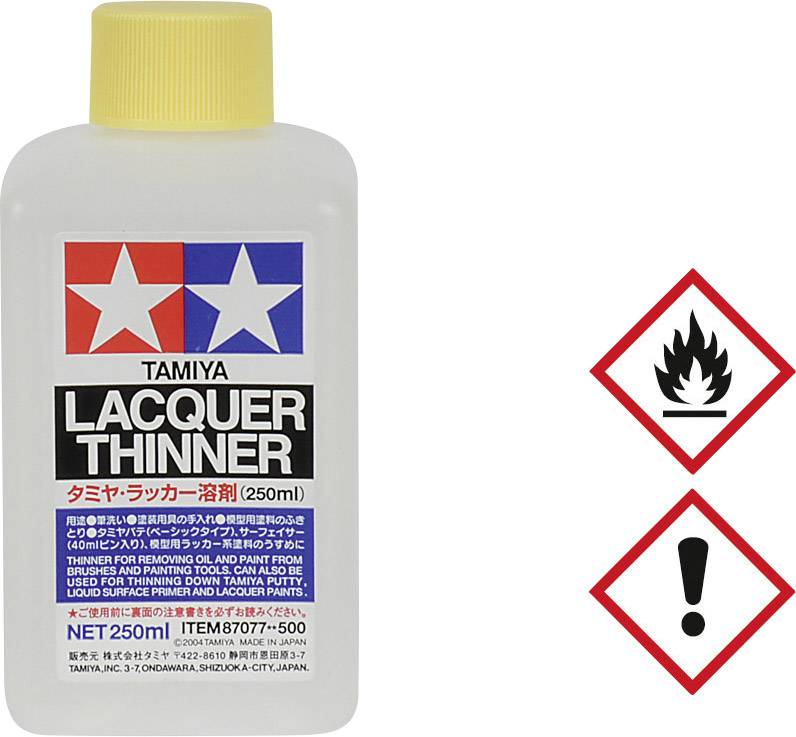 'Razredčilo laka 250 ml steklenica. Logotip TAMIYA. Opozorilni simboli: Plamen in klicaj, ki nakazujeta vnetljivost in previdnost.'