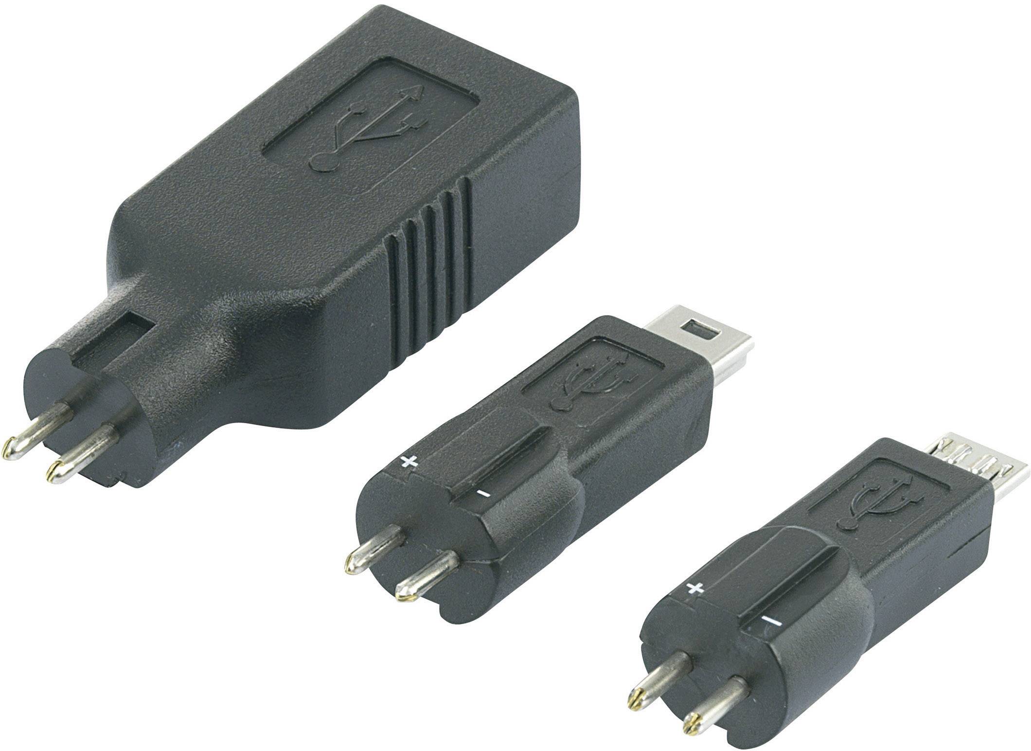 'Trije črni USB adapterji z različnimi priključki, položeni drug ob drugem na beli podlagi.'