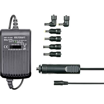Nätadapter med fem utbytbara kontakter och billaddare, lämplig för 100-240V ingångar och 15V/3000mA utgång. Märkning: 'Voltcraft'.