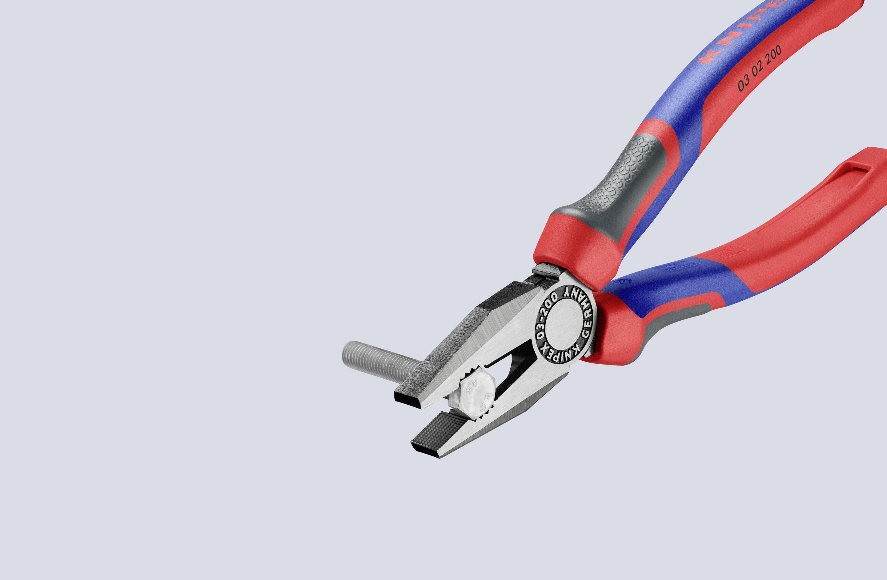 En röd och blå kombinationstång klipper igenom en tråd. Den har ett ergonomiskt grepp och en blank metalllegering.