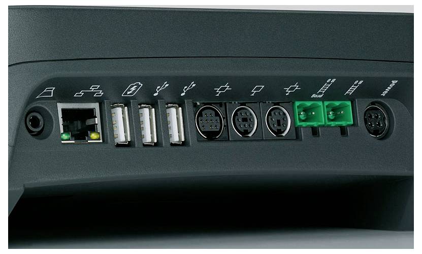 Baksidan av en elektronisk enhet med diverse anslutningar: Ethernet, USB-portar, seriella portar och gröna klämmor.