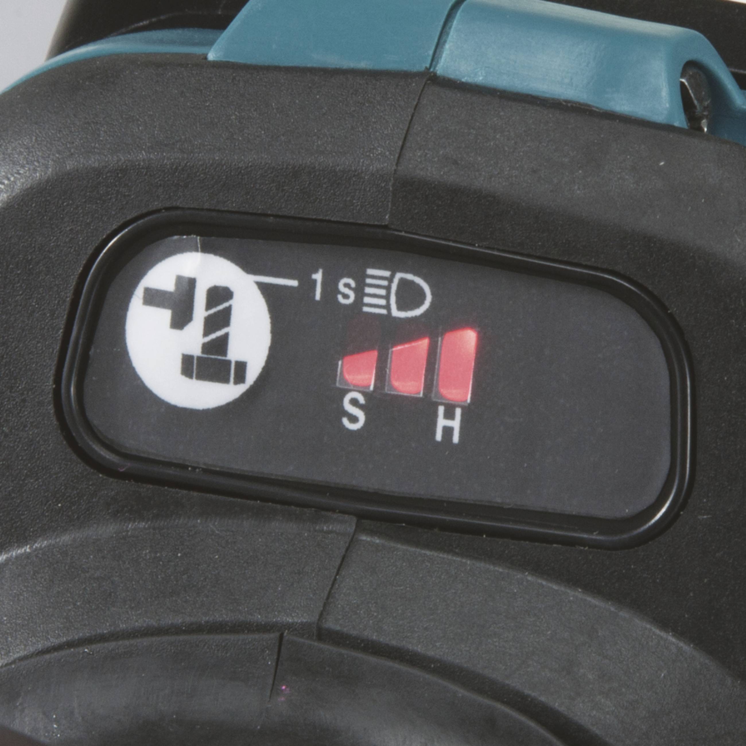 Närbild av en omkopplare med tre lägen: S, H och en motsatt riktning med symbol för hastighetsändring.