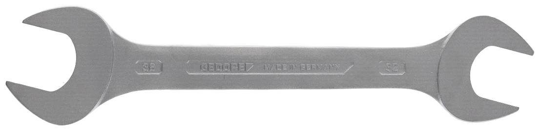 En silverfärgad skiftnyckel med öppna ändar, modellnummer 'DIN 3117', på en vit bakgrund.