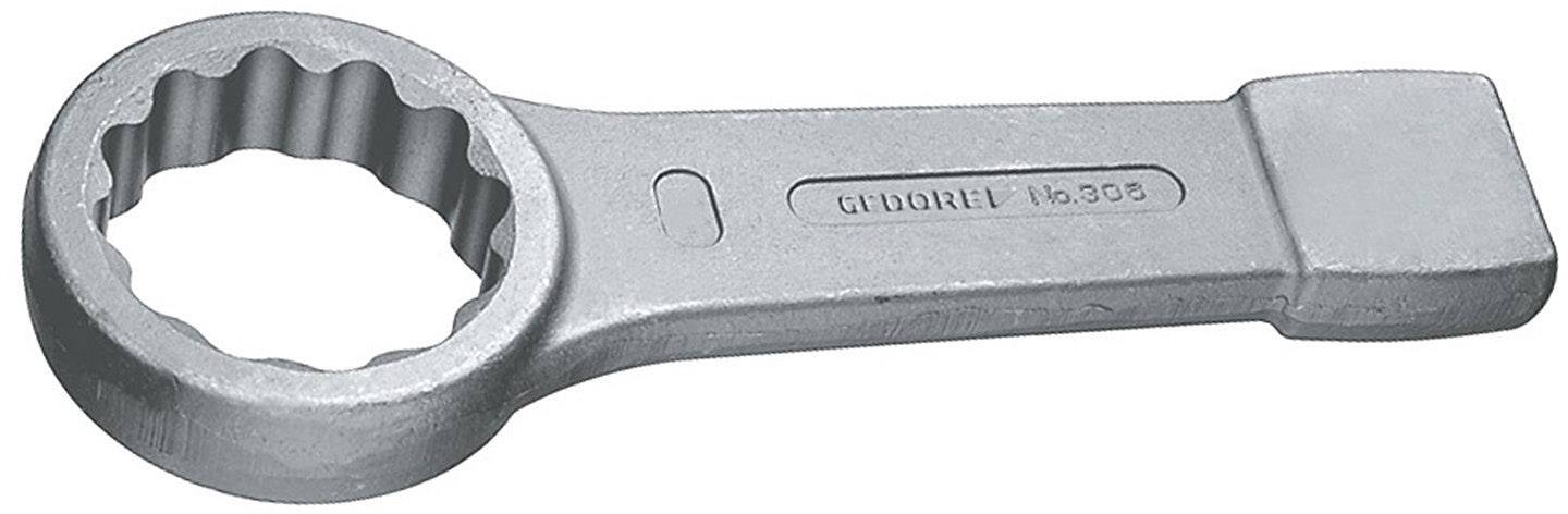 Metallnyckel med rundad, tandad ände och rektangulär greppyta.