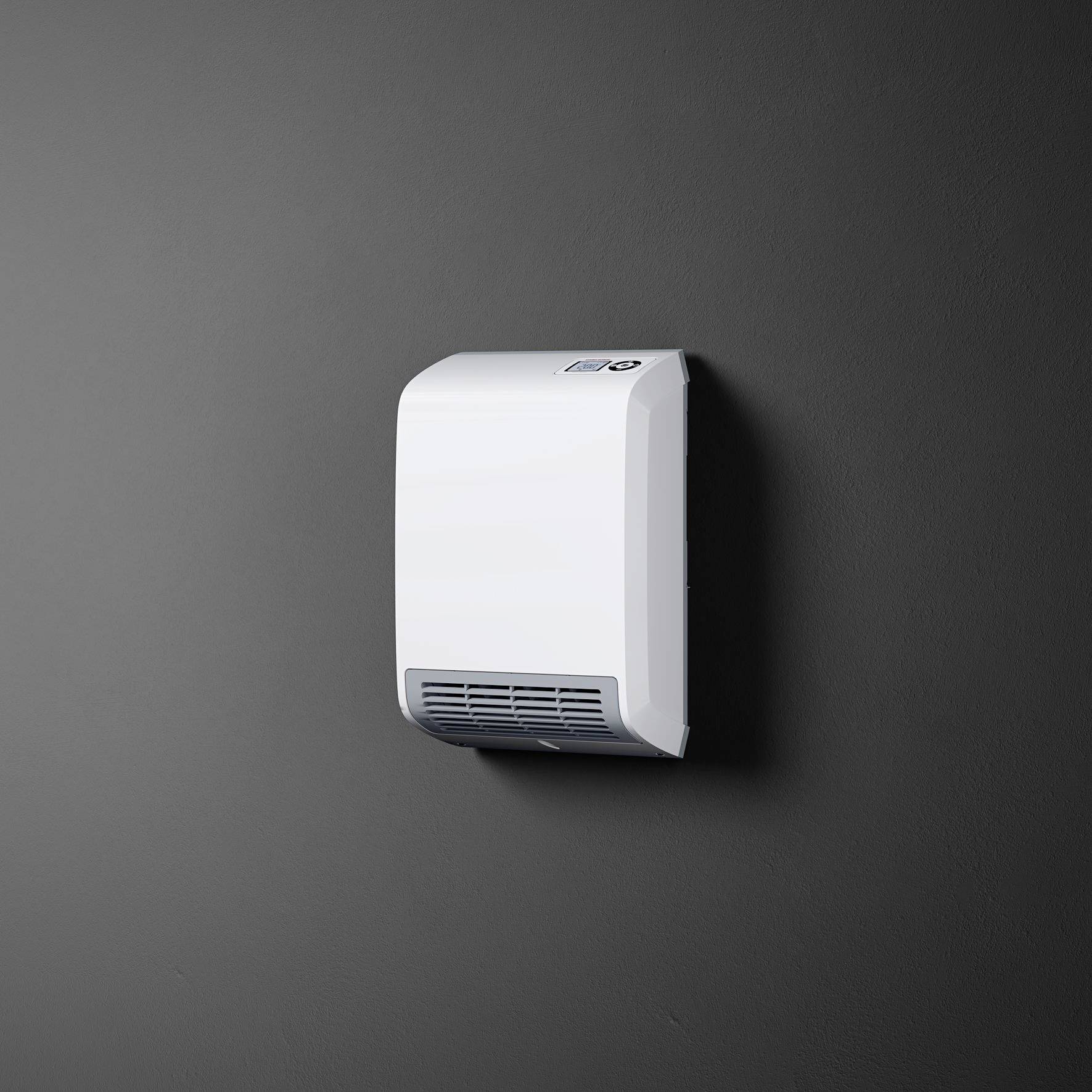 En vit händtork är monterad på en grå vägg. Den har en slät yta och ventilationsspringor nedtill.