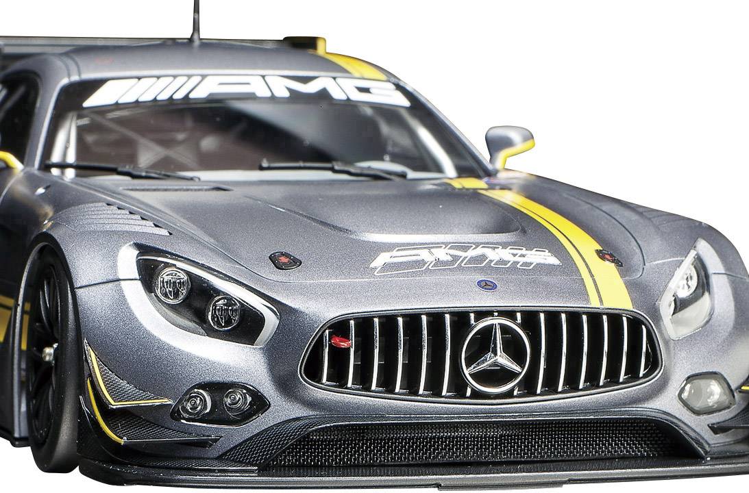 Silverfärgad Mercedes-AMG-racerbil framifrån, med svart kylargrill och gula accenter.