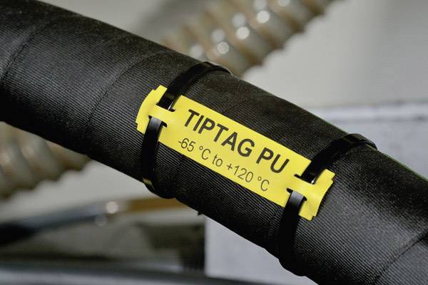 Svart kabel med gul etikett där det står 'TIPTAG PU -65 °C till +120 °C', fäst med kabelbindare.