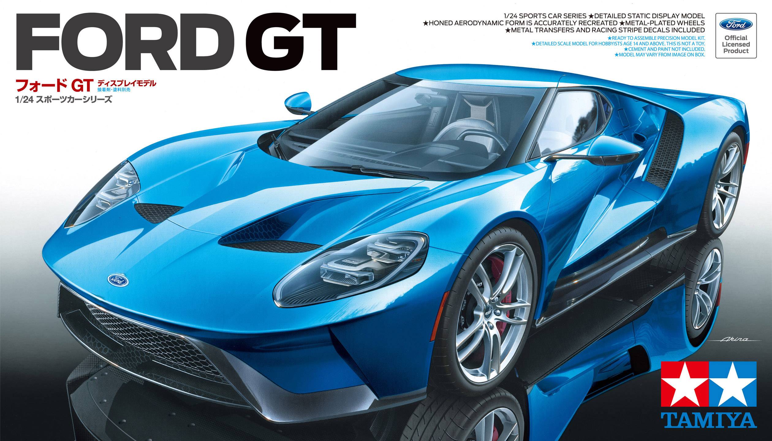 Blå Ford GT sportbilsmodell från Tamiya i skala 1:24, fotograferad framifrån vänster, på reflekterande yta. Tamiya-logotyp nere till höger.
