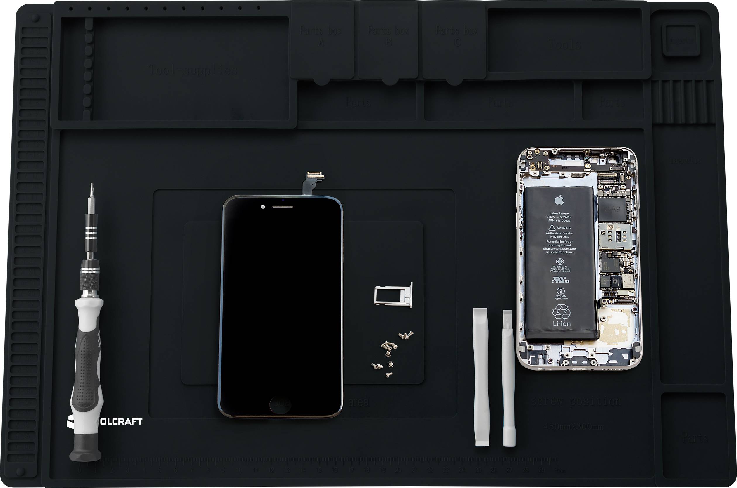 Smartphoneraparationsset: En smartphone med borttagna delar och verktyg på en matta. Visar skärm, batteri och skruvar.