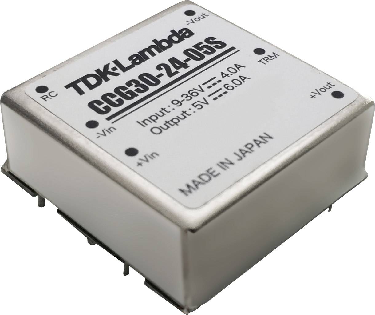 En silverfärgad TDK-Lambda spänningsomvandlare, modell CCG30-24-05S, visar ingångs- och utgångsparametrar. 'Made in Japan' är graverat.