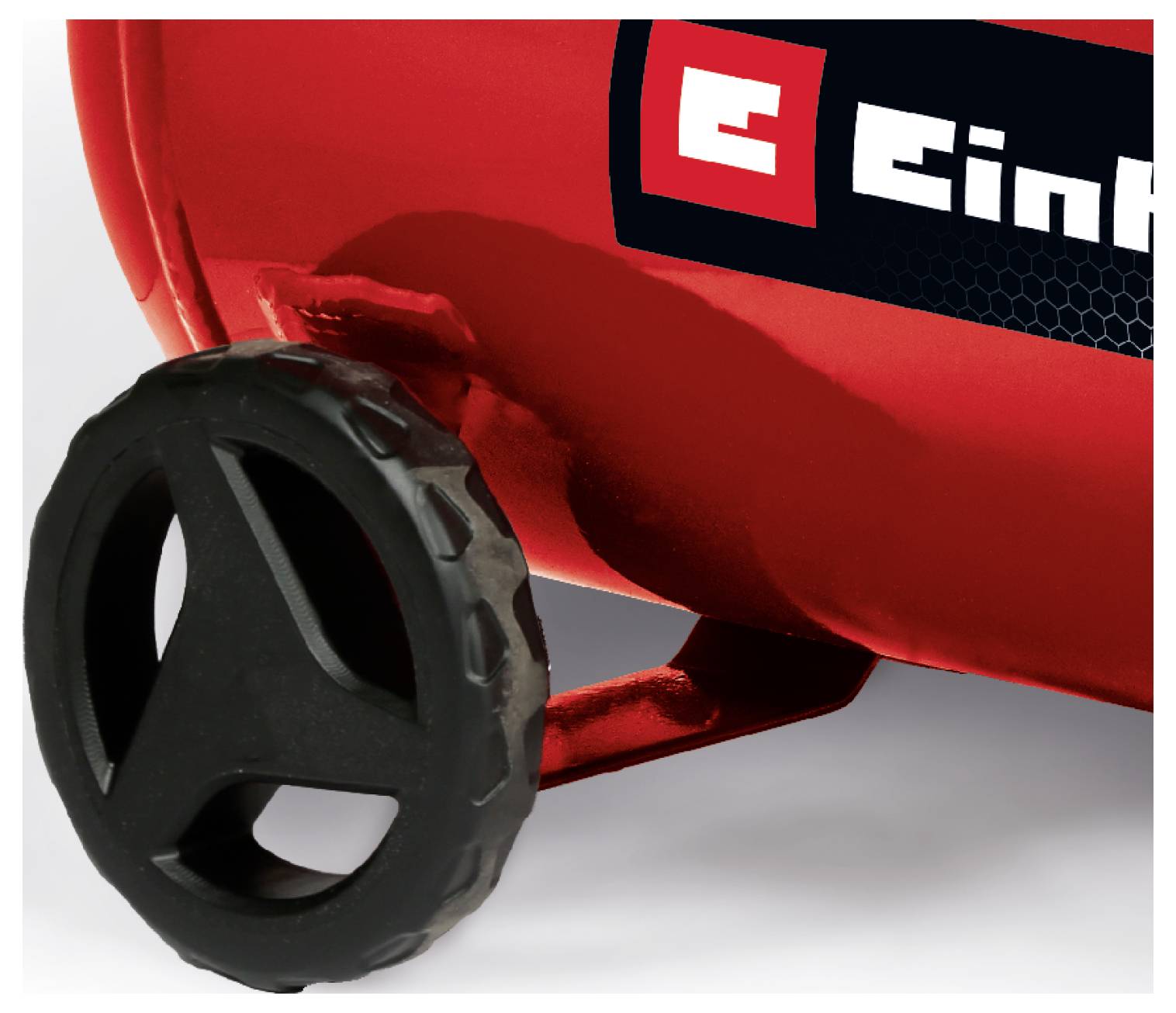 Närbild av en röd maskin med ett svart hjul eller vred och en delvis synlig "Einhell"-logotyp på sidan.