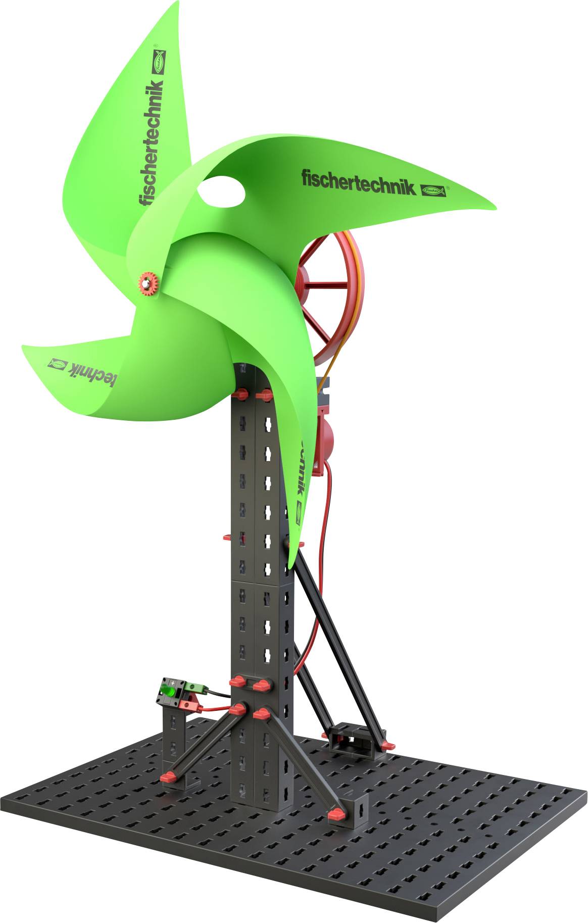 En modell-vindkraftverk med grön rotor från 'fischertechnik', monterad på en svart plattform med röda och svarta detaljer.