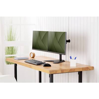 Ett minimalistiskt skrivbord med en dubbel monitoruppsättning, ett tangentbord, en mus, en pennställ och en bok.