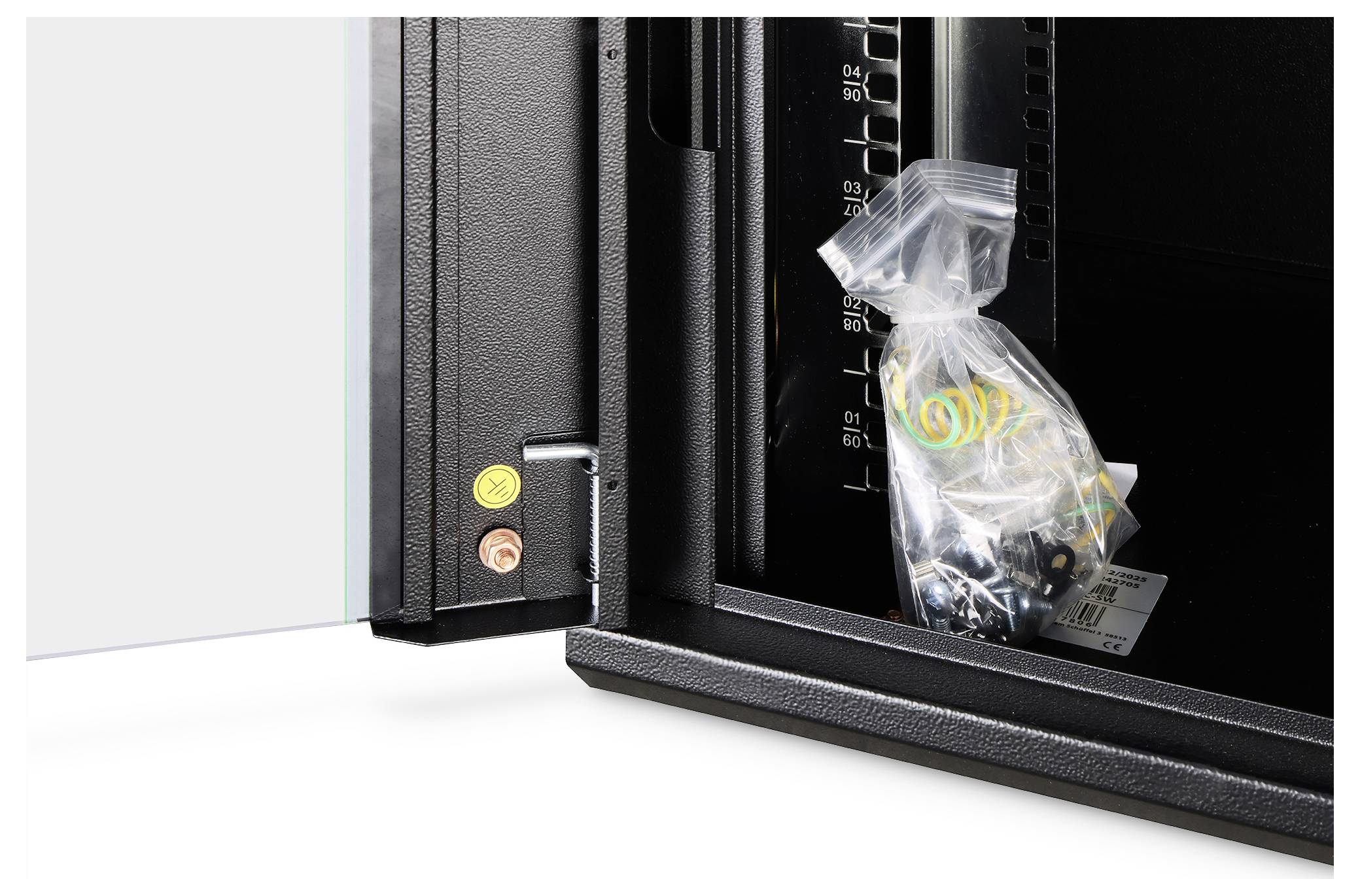 En öppen säkerhetsdörr avslöjar en plastkasse som innehåller skruvar och rawlplugs inuti ett svart metallhölje med måttmarkeringar.