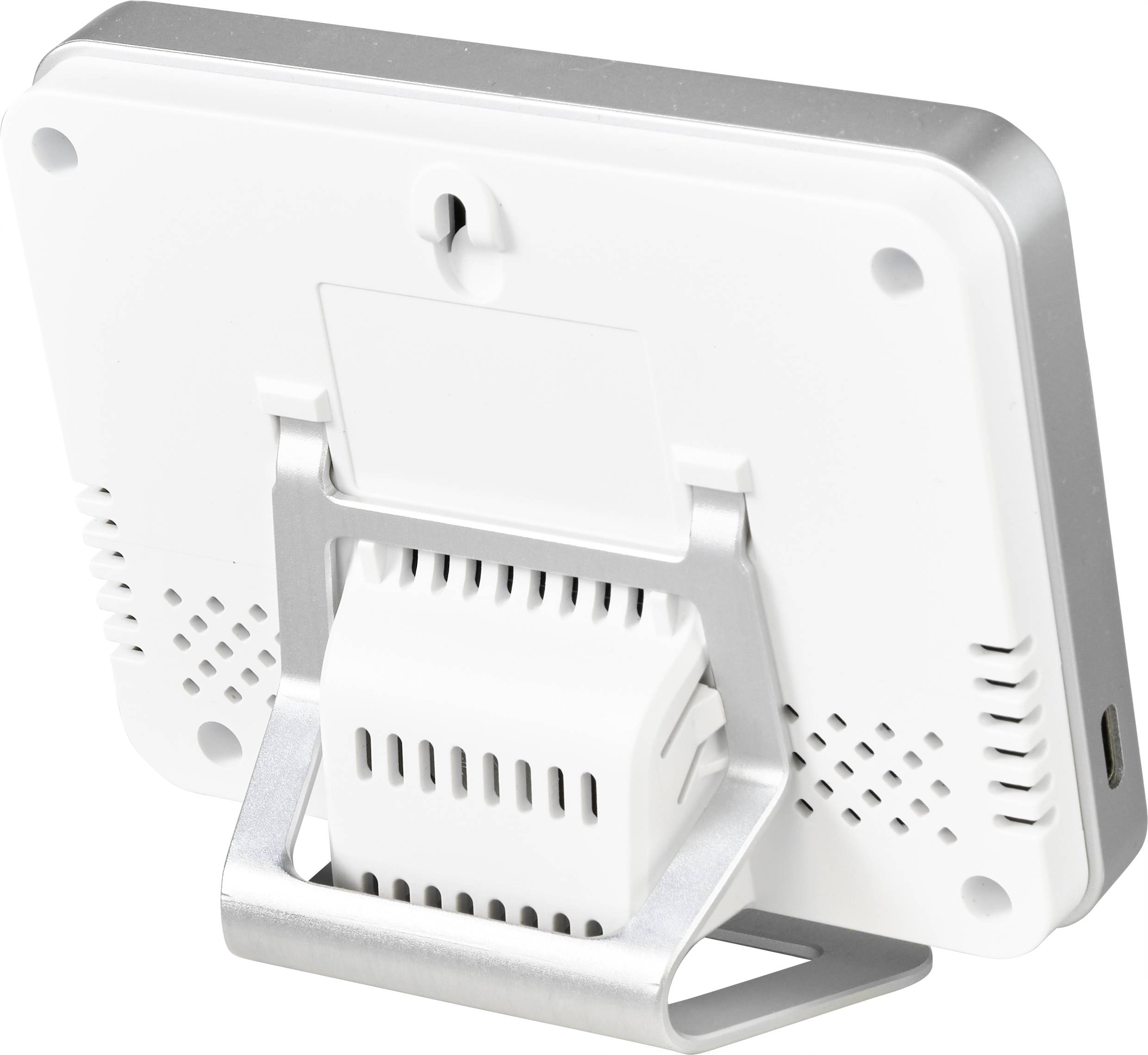 En liten, vit bordsapparat med ställ, ventilationsöppningar och en anordning för väggmontering, sannolikt ett termo-hygrometer.