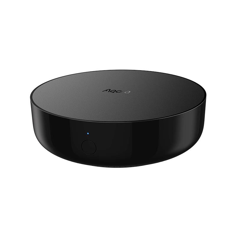 Svart, rund, tunn smart home-brygga med en liten knapp, lämplig för anslutning av olika smarta enheter.