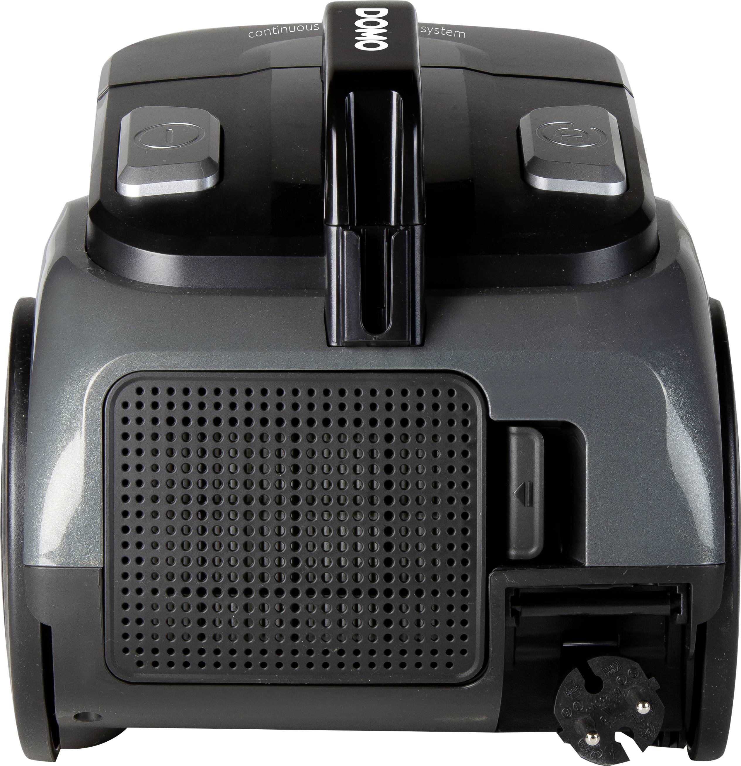 En svart-grå dammsugare sedd framifrån med en avtagbar dammsamlare och manöverknappar ovanpå.