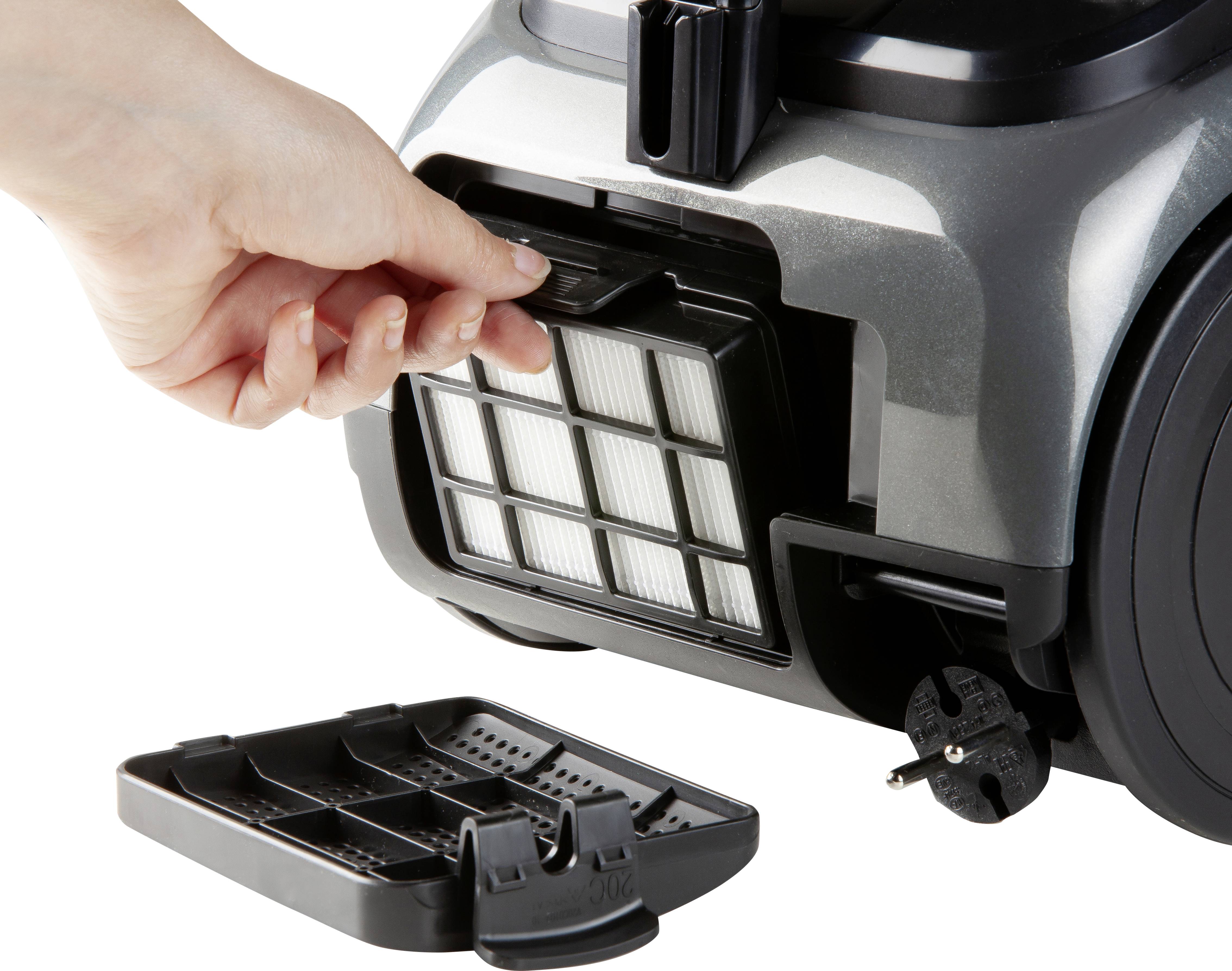 En hand öppnar HEPA-filtret i en dammsugare och visar byteprocessen.