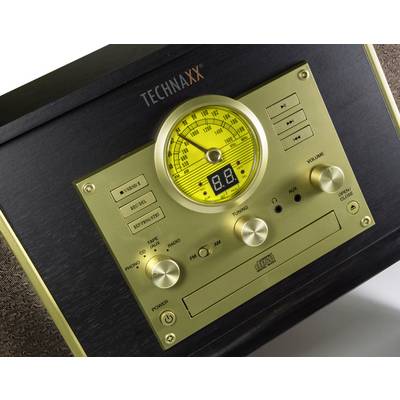 Äldre radioinspelare med guldfront, belyst frekvensvisning och flera reglage för radio och CD.