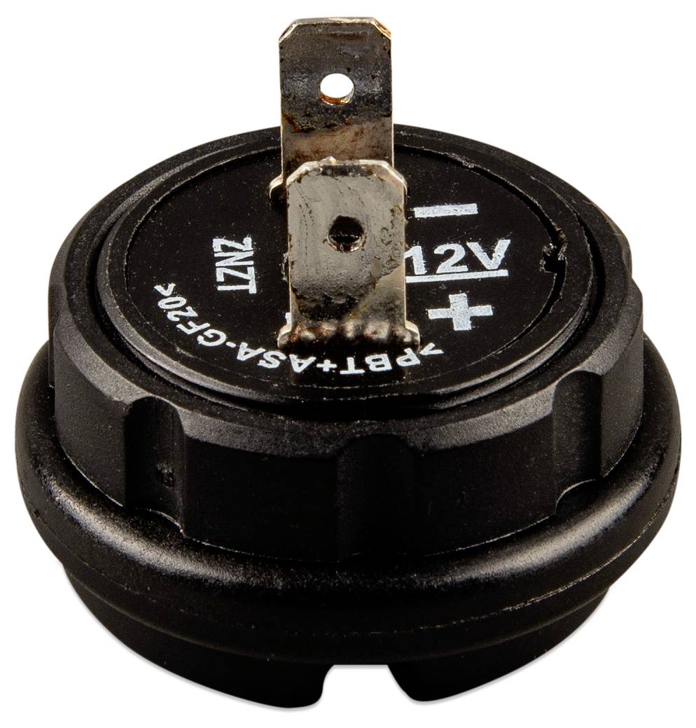 En svart cirkulär komponent med en utstickande metallkontakt, märkt '12V +' på ovansidan.