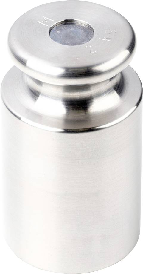 Ett silverfärgat metallvikt, cylinderformat, stående upprätt.