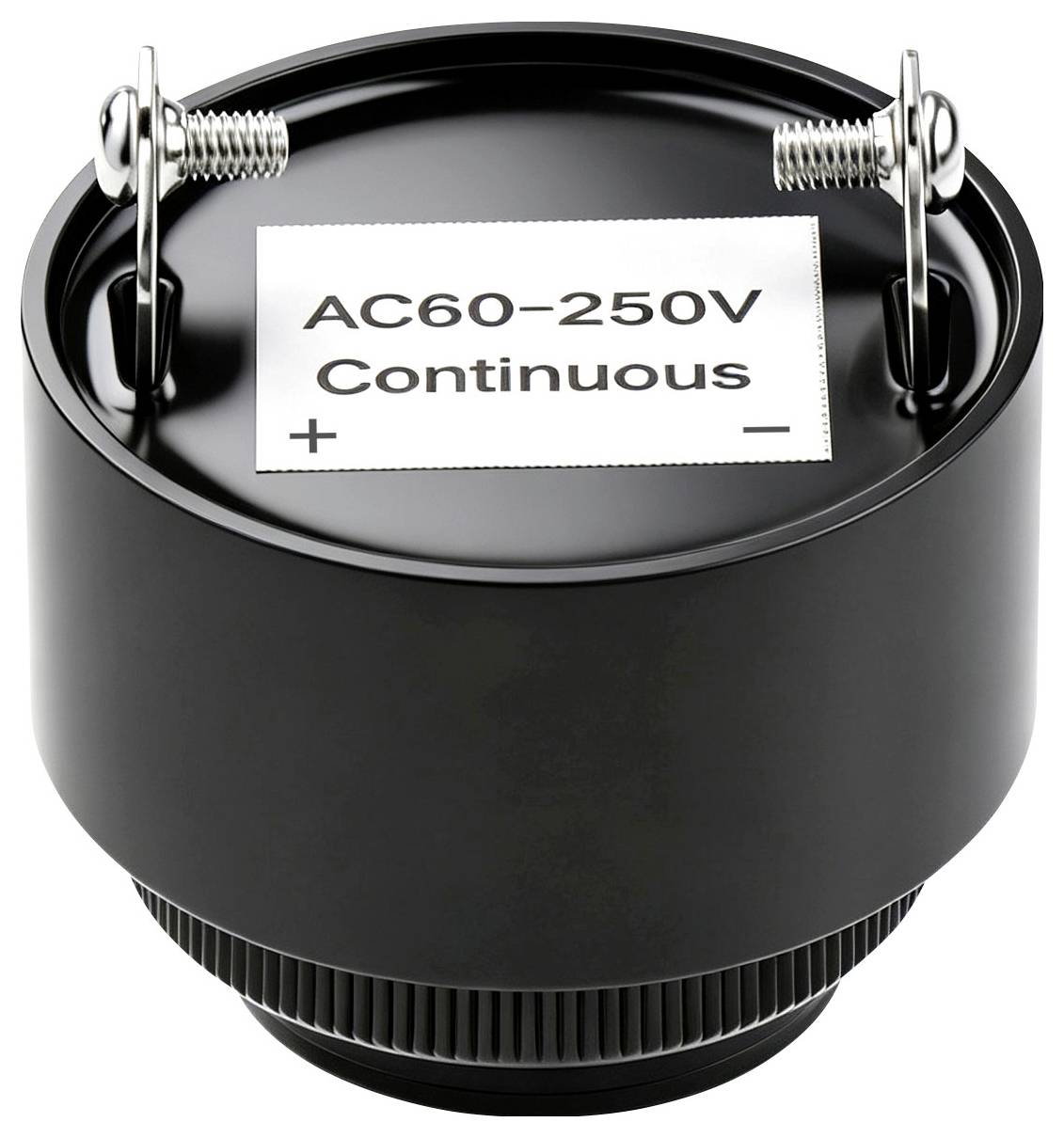 Svart cylindrisk elektrisk komponent märkt "AC60-250V Continuous" med + och - terminaler på toppen.