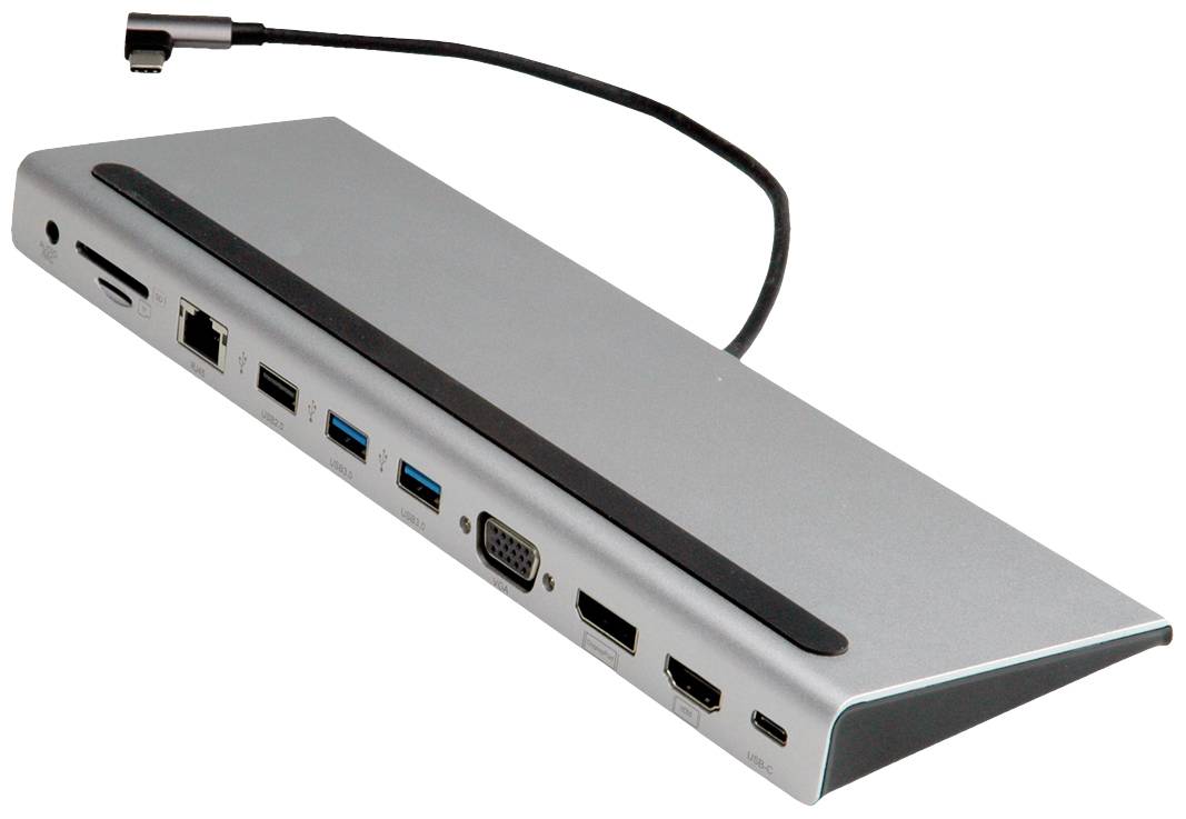 Silverfärgad dockningsstation med flera anslutningar, inklusive USB, HDMI, VGA och Ethernet, ovanpå ett kort kabel med svart kontakt.