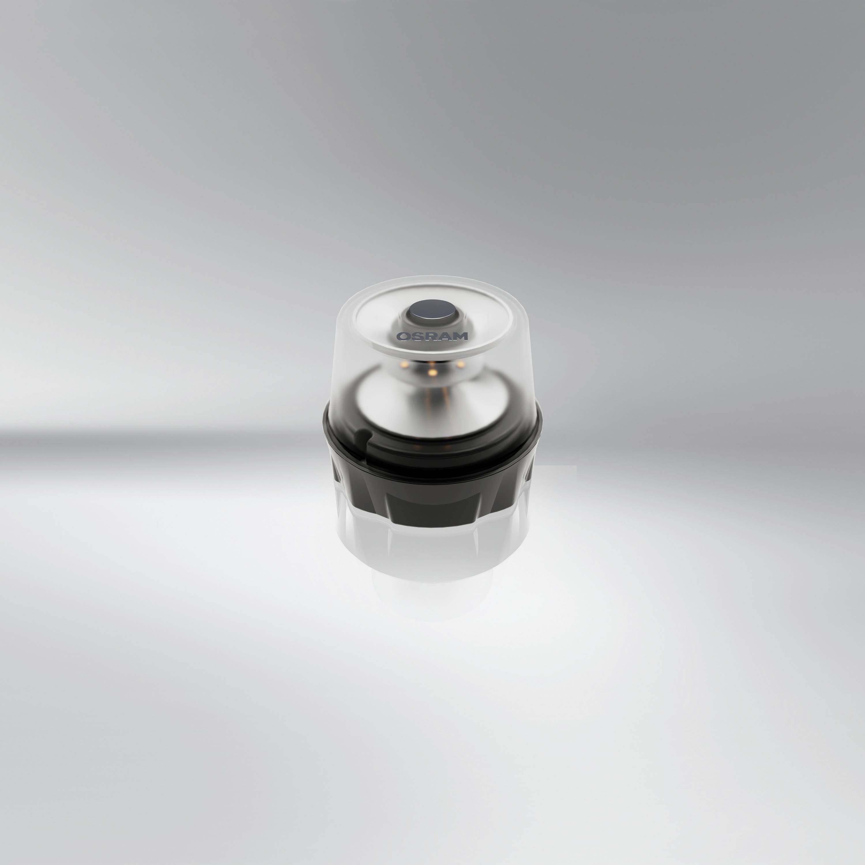 En rund, genomskinlig trycknapp med texten 'CELLMAN' på grå bakgrund.