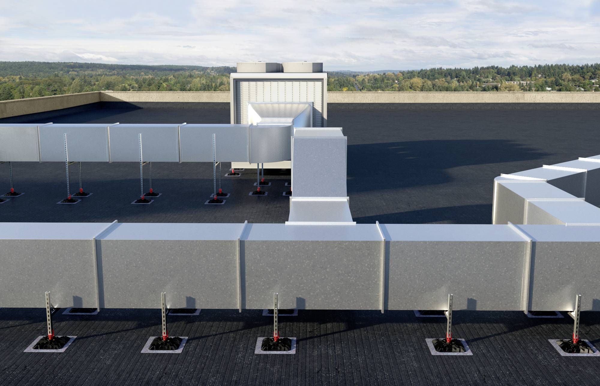 Ventilationssystem på ett platt tak med utsikt över en skogsbeklädd landskap i bakgrunden.