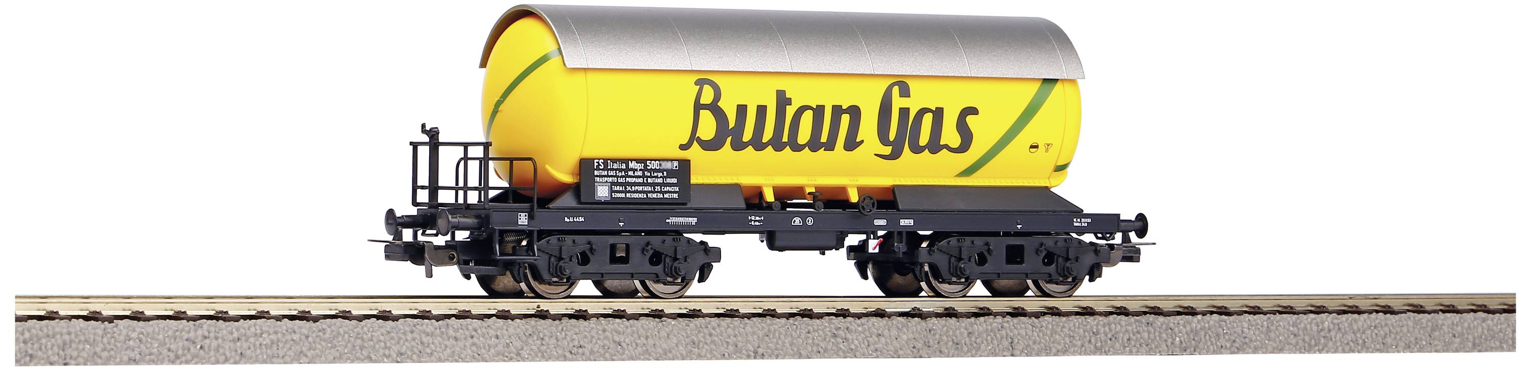 Gul godsvagn med silverfärgat tak och texten 'Bulan Gas' på ett järnvägsspår.