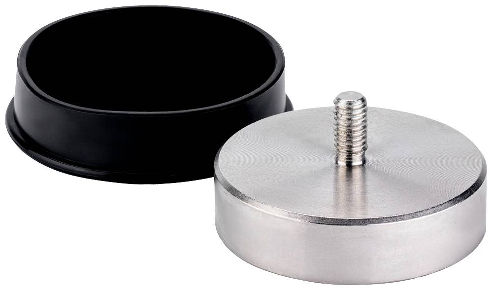 En rund metallplatta med en gängad skruv ligger bredvid ett svart plastlock.