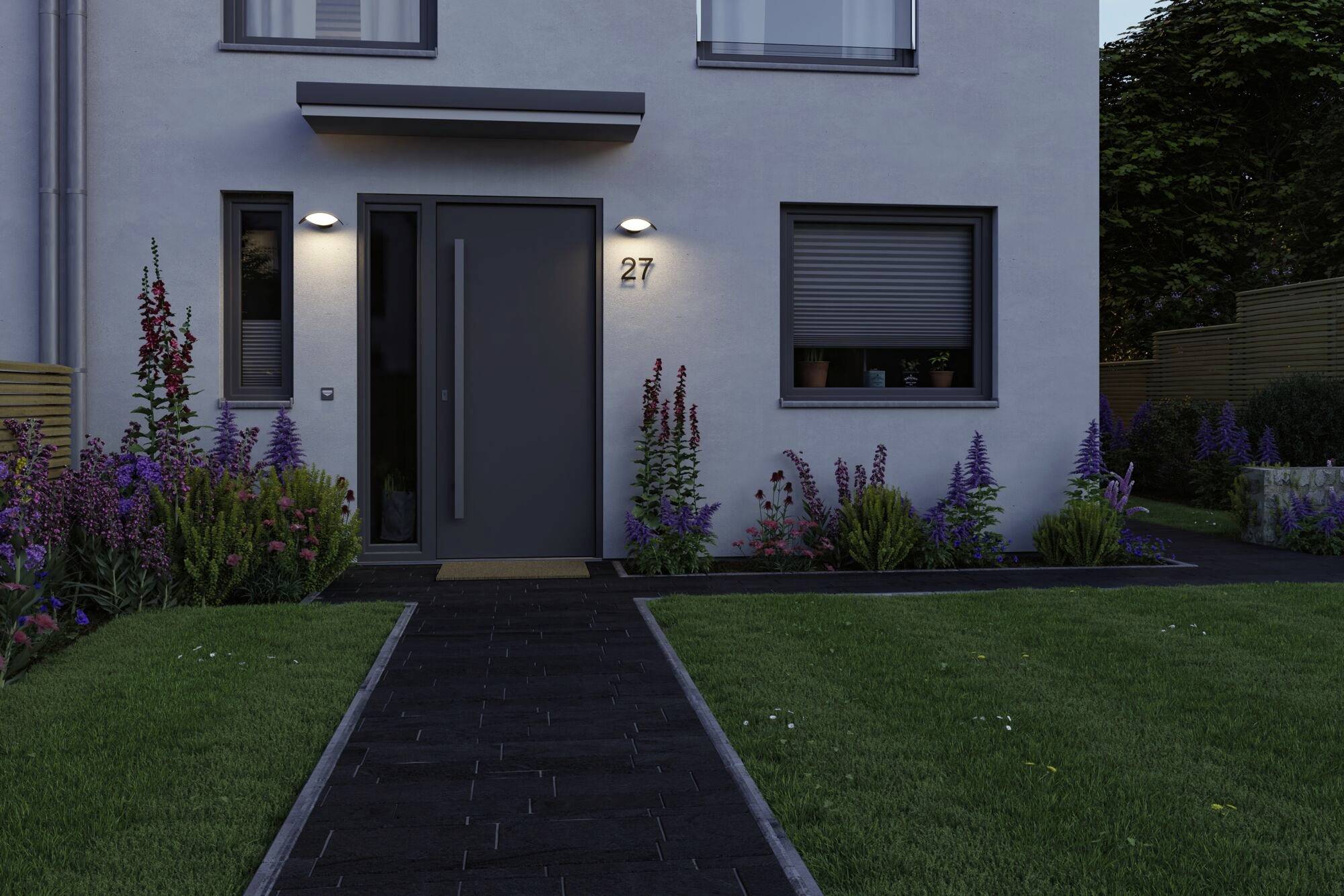 Ett modernt hus med en mörk ytterdörr, omgivet av en välskött trädgård med rabatter. Husnummer '27' på väggen ovanför dörren.