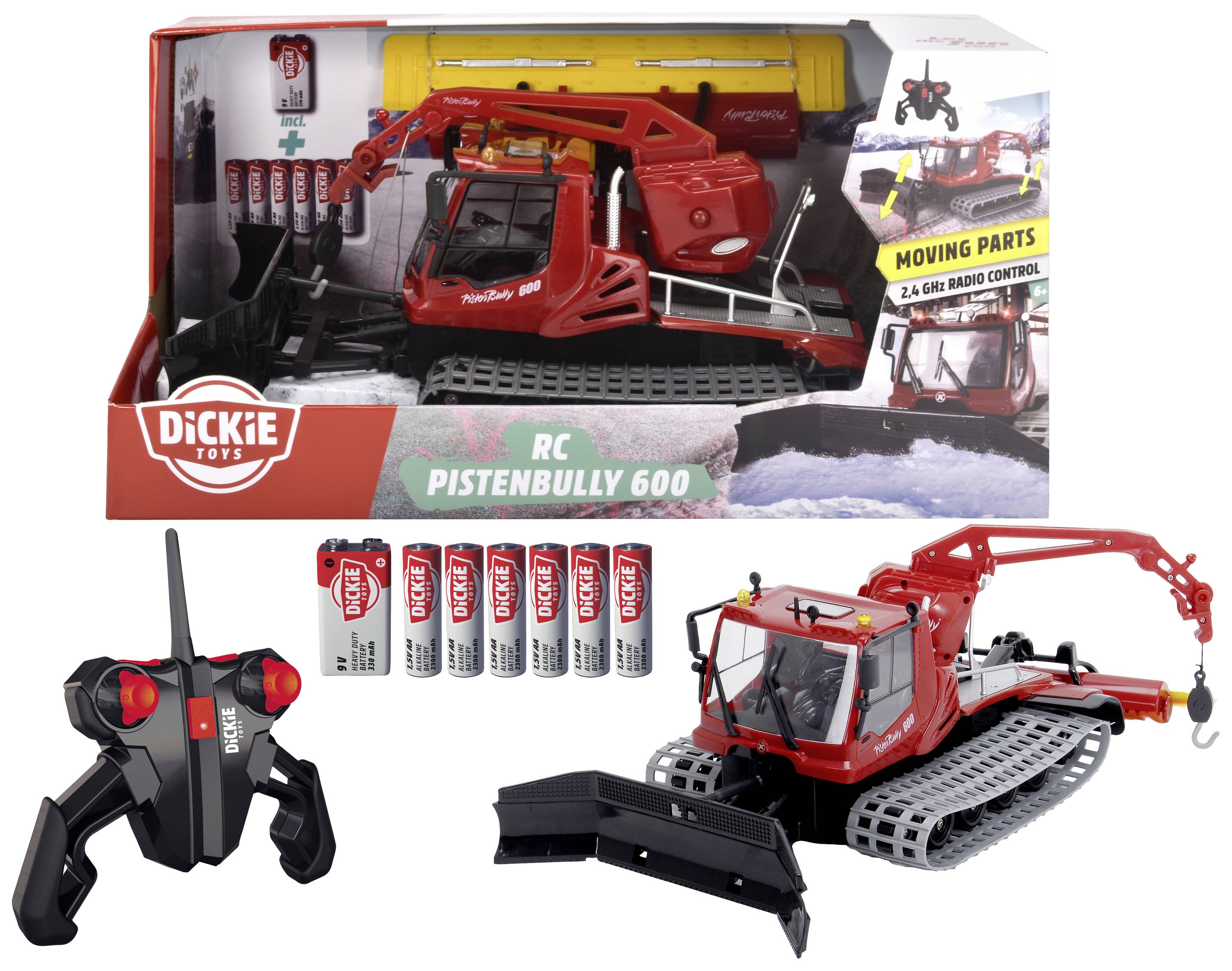 RC Pistenbully 600 lekset med fjärrstyrt snöfordon, manövrerbar arm och snöplog samt fjärrkontroll och batterier i förgrunden. Förpackning i bakgrunden.