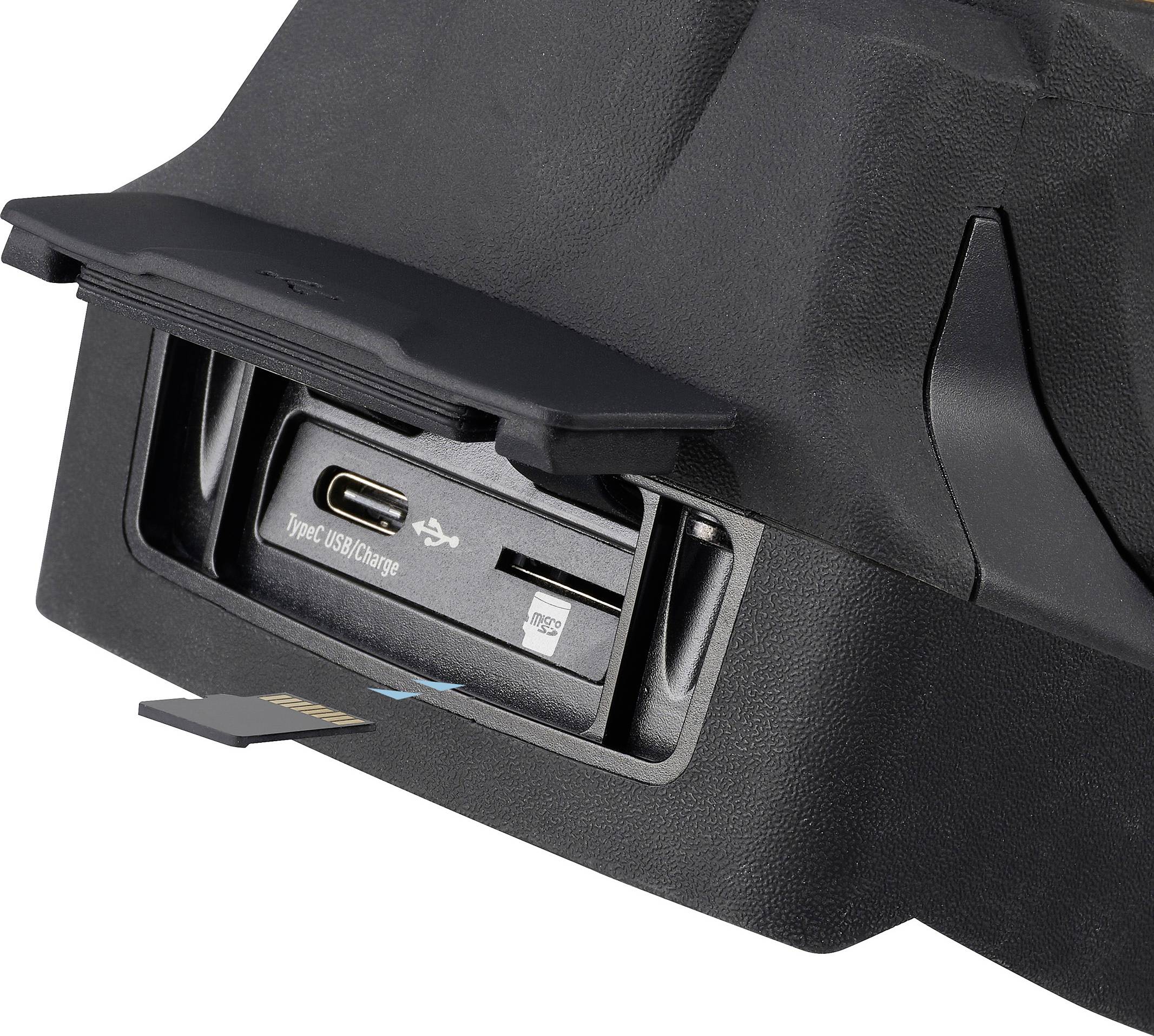 Anslutningar dolda i ett fack: USB-C, USB-A och SD-kortplats, lämpliga för mångsidiga kopplingar i tekniska enheter.