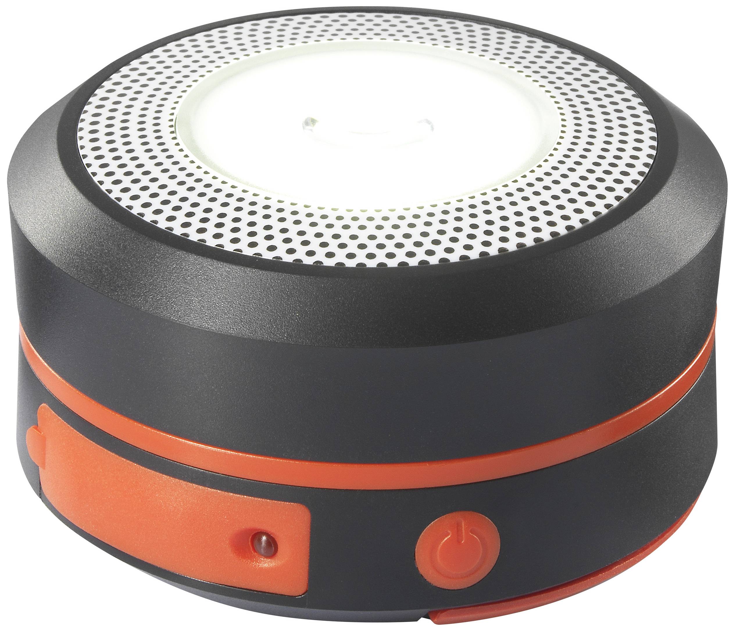 Bärbar LED-lampa i svart med orangedetaljer, rund, kompakt, med ett stort, centralt lysande område.