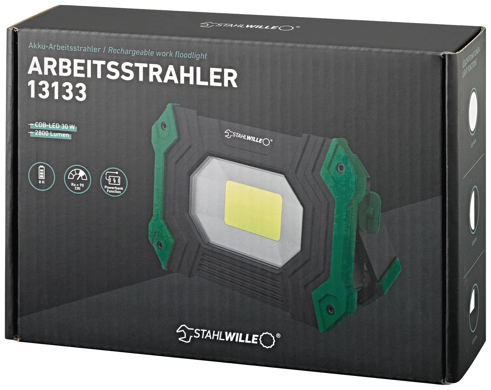 'Stahlwille Arbeitsstrahler 13133' i förpackning. Batteri-LED-strålkastare med 20 W och 2000 lumen. Laddare och USB-anslutning visas.