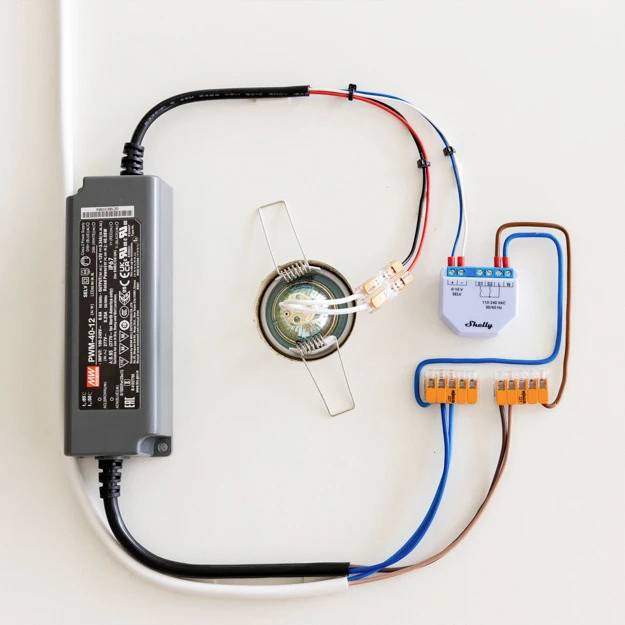 Elektrisk installation på väggen: Transformator, LED-drivdon och kabelanslutna kopplingsplint är sammankopplade för att styra en armatur.