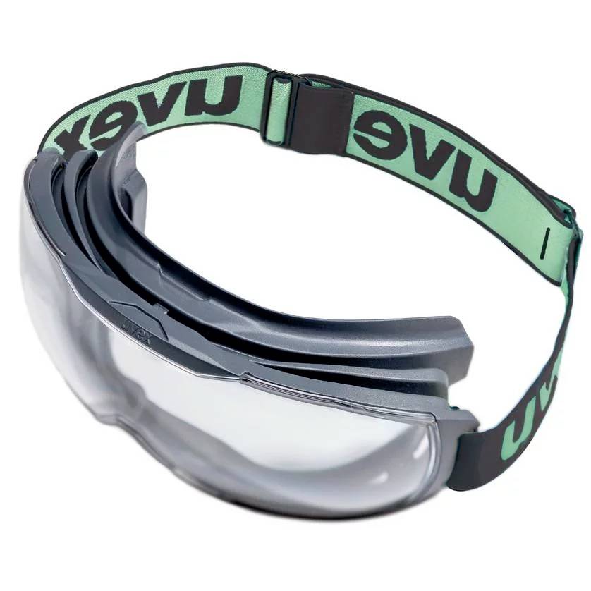 Skyddsglasögon med justerbart gummiband och transparenta glas, erbjuder skydd mot damm och stänk.