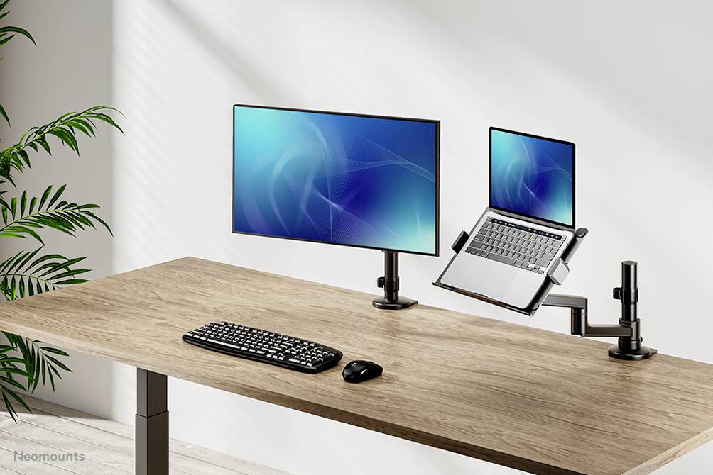 Höj- och sänkbart skrivbord med två skärmar, trådlöst tangentbord och mus. Perfekt för flexibelt arbete och ergonomi.