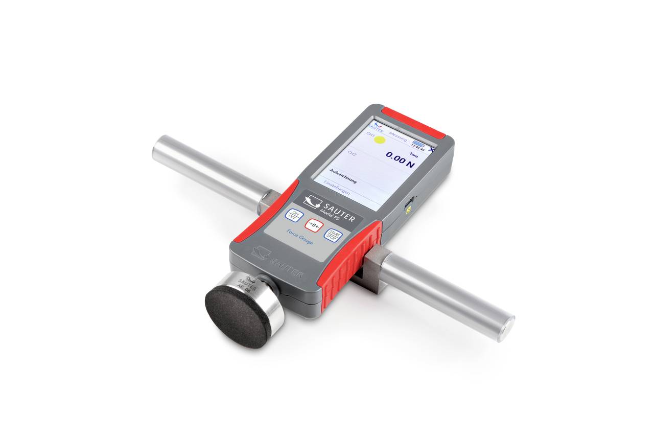 En bärbar mätapparat för bestämning av materialyters hårdhet, utrustad med en digital display och ett cylindriskt överstycke.