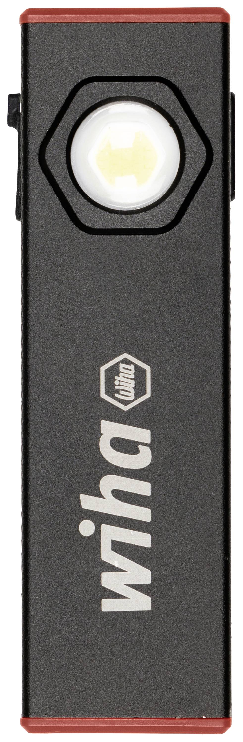 Bärbar LED-belysning från Wiha, avlång svart form med röd kant, hexagonal ram runt linsen på framsidan.