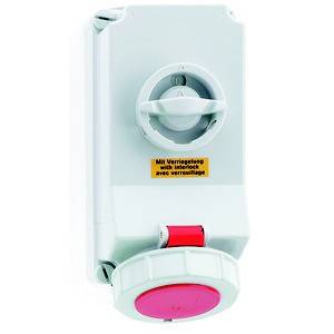 Väggmonterad säkerhetsbrytare med låsning, rund röd nödstoppsknapp, grått hölje, gul varningsetikett.