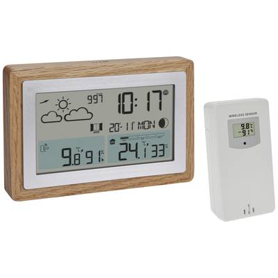 Digitalt termometer med träram visar väderdata: sol, lufttryck, temperatur inomhus '24,1°C', utomhus '9,8°C'. Trådlös sensor bredvid.