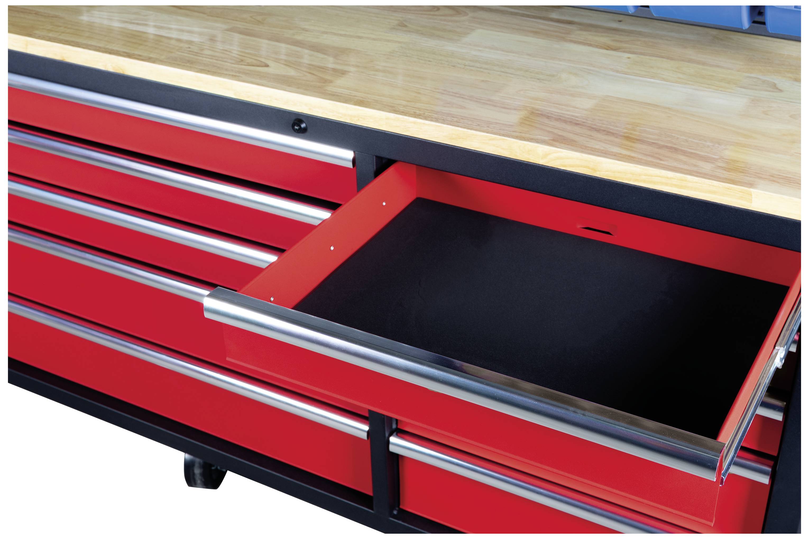 Röd arbetsbank med öppet skjutfack, stabil träarbetsyta, flera slutna lådor därunder, på hjul.