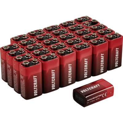 En hög med röda 9V-batterier av märket VOLTCRAFT, symmetriskt arrangerade med ett separat batteri liggande framför.