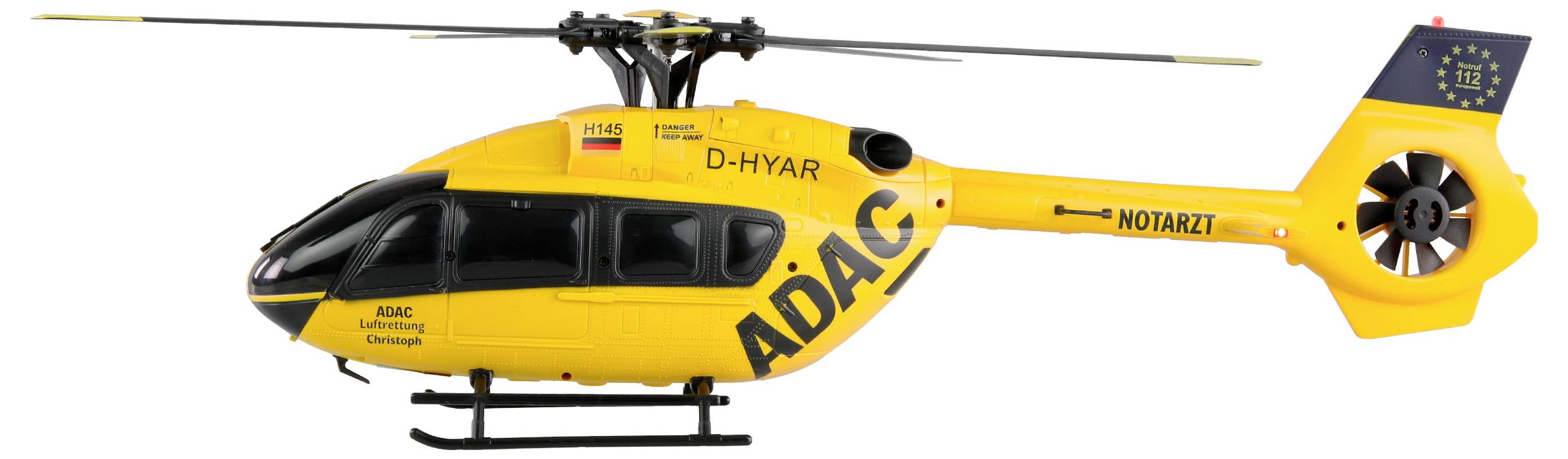 Gul räddningshelikopter med texten 'ADAC' och 'Notarzt' på sidan, svävar i luften.